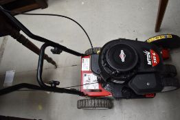 A petrol driven lawn edger , having Briggs and Stratton engine, model MTD 550G