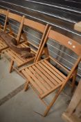 A set of four modern deck style folding chairs