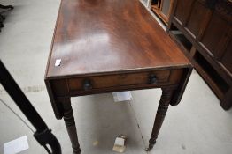 A Victorian mahogany Pembroke table having drawer to one end, dummy drawer to the other , on