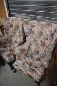 A pair of 19th century design wing back armchairs, with foliate pattered covers