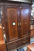 An Edwardian mahogany wardrobe having four drawers to base