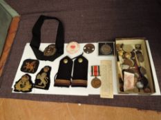A collection of Military Buttons, Epaulettes, Cloth Badges and a George V Special Constable Medal to