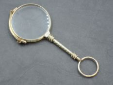 A yellow metal lorgnette of traditional form, spring working, no marks
