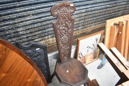 A traditional dark oak spinning chair