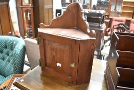 A small pitch pine wall cabinet