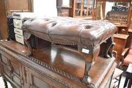 A reproduction footstool having buttoned leather top