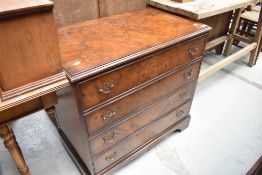 A reproduction yew wood chest of four drawers