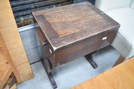 An early 20th century mahogany sewing table, with trestle style base
