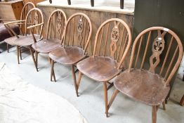 A set of six (four plus two) Ercol chairs having fleur de lys style hoop and stick back, and a