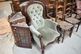 A Victorian mahogany scroll frame armchair having later green dralon upholstery