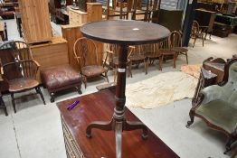 A 19th Century oak occasional wine or similar table having circular top turned column and tripod