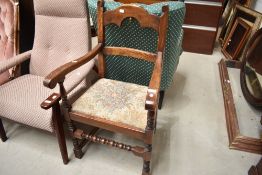 A traditional oak frame carver chair