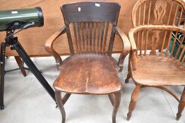 A late 19th or early 20th Century oak solid seat office armchair
