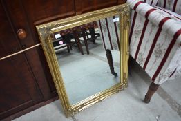 A reproduction gilt frame wall mirror