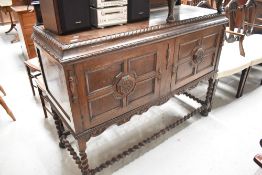 An early 20th Century Jacobean style sideboard having twist frame, width approx. 133cm
