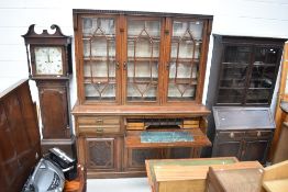A Victorian mahogany bookcase having triple display section the base having one large and two