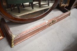 An antique copper fire fender