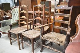 Five assorted traditional rush seated chairs including ladder back and carvers