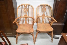 A pair of traditional stripped Windsor armchairs, having crinoline stretcher