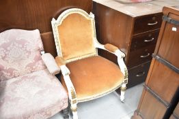 A French style painted armchair having gold dralon upholstery