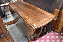 A reproduction oak gateleg dining table