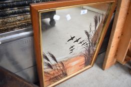 A vintage wall mirror having flying duck decoration