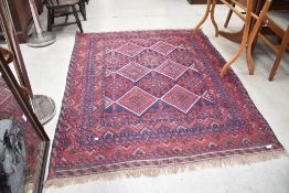 A Persian style rug, in blue and red tones, approx 180 x 143cm