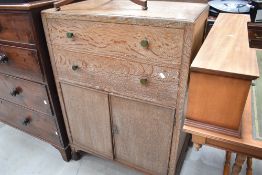 A mid 20th Century limed oak tallboy