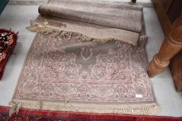 A traditional styled rug having fringed edges.