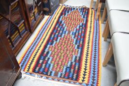 A vintage wool rug, multi colour design