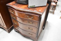 A reproduction serpentine chest of four drawers