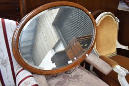 An early 20th century mahogany oval wall mirror