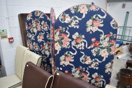 A vintage trifold room divider or modesty screen