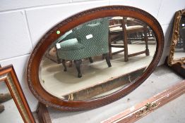 An early 20th Century mahogany oval wall mirror