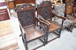 A fine pair of oak hall armchair in the Wainscott style