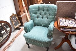 A reproduction button back armchair having Queen Anne style legs
