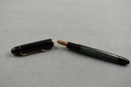A Pelikan 140 piston fill fountain pen in green striated pattern and black cap having Pelikan 14ct