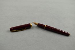 A Watermans Ligne 60 cartridge/converter fountain pen in red with band to base of the cap having a