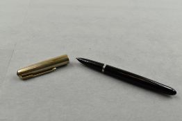 A Parker 51 button filler fountain pen in black with gold cap. Approx 13.9cm