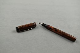 An Unnamed eyedropper fountain pen in red and black wood grain having two narrow bands to the cap