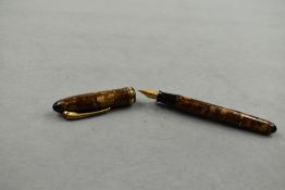 A Stylomine 303 fountain pen in gold/brown marble with a broad and narrow band to the cap having a