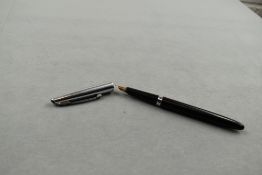 A Waterman Cartridge/ Converter fountain pen in black having steel cap with Waterman 14ct nib.