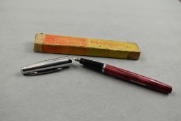 A Platignum Golden Platignum leverfill fountain pen in pink with ribbed steel cap in original box.