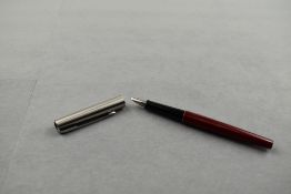 A Parker 15 Mixy fountain pen in burgundy with brushed steel cap. Approx 12.5cm