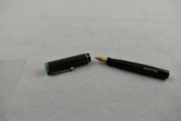 A Moore's leverfill fountain pen in black with blue top to cap and single narrow band having a