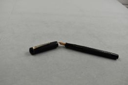 A De La Rue 540/90 leverfill fountain pen in black engine turned decal having Warrented 14ct nib.