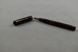 A Conway Stewart 286 leverfill fountain pen in red marble with single narrow band to the cap