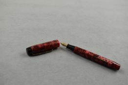 A Kingswood leverfill fountain pen in rose pink and black marble with two narrow bands to the cap