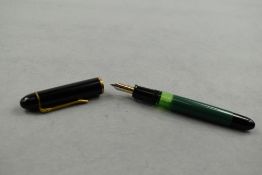 A Pelikan 120 piston fill fountain pen in green with black cap having Pelikan EF nib. Approx 12.4cm