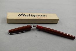 A Platignum Silverline fountain pen in red with single band to cap having Platignum First Quality